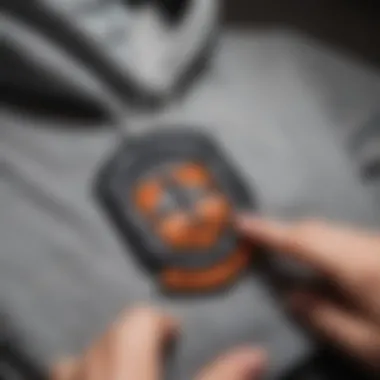 Close-up of an iron-on patch being applied to a hoodie with an iron