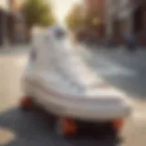 Classic pair of white Converse shoes on a skateboard deck