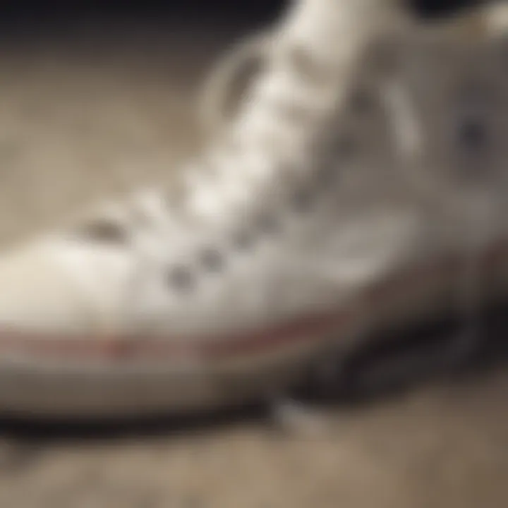 Close-up of worn white Converse shoes showcasing their durability