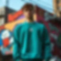 Teal crew neck sweatshirt displayed against a vibrant urban backdrop
