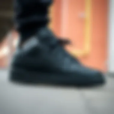 Side profile of Reebok all black skate shoes highlighting their structure and grip.