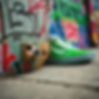 A skateboard deck adorned with graffiti art next to a pair of green vans