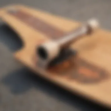 Close-up of the Loaded Longboard Tan Tien deck showcasing its unique shape and graphics