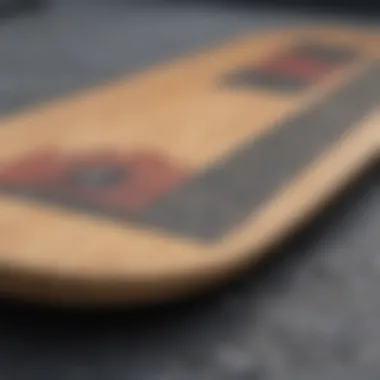 Close-up of a skateboard deck displaying width variations and grip tape texture.