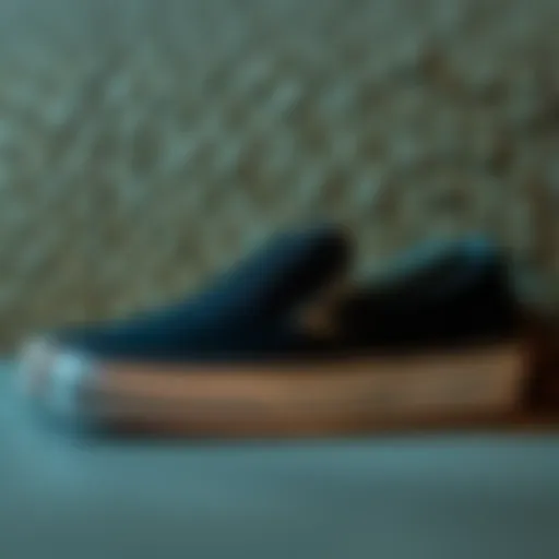 Classic black slip-on Vans against a textured surface