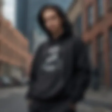 A fashion-forward individual styling the black dream hoodie in an urban setting