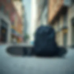 A black plain backpack resting against a skateboard on a city street