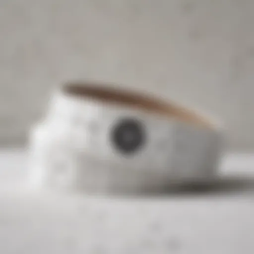 Close-up view of a white Vans belt against a textured backdrop