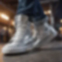 A close-up view of silver Converse high tops on a skateboard