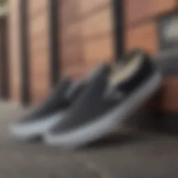 A classic pair of Vans Slip-On black shoes placed on a skateboard